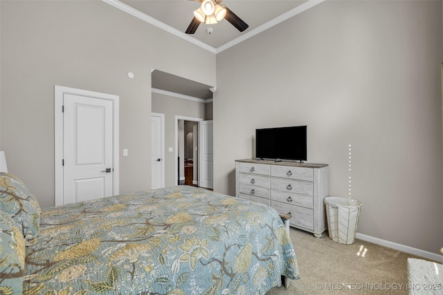 carpeted bedroom featuring ceiling fan and crown molding