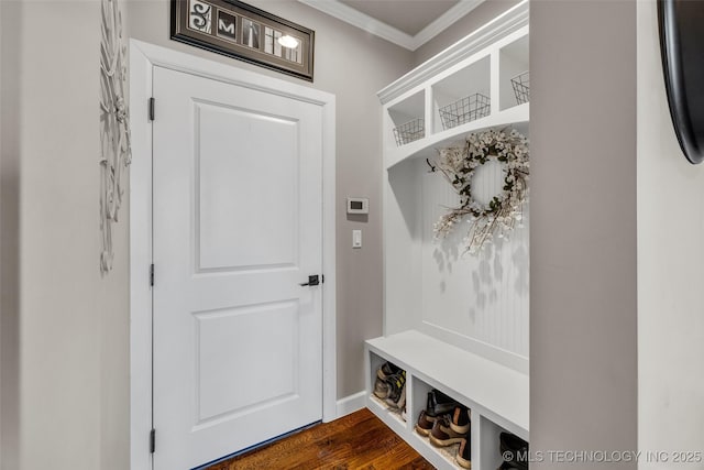 mudroom with dark wood-type flooring and crown molding