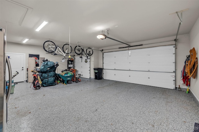 garage featuring stainless steel fridge and a garage door opener