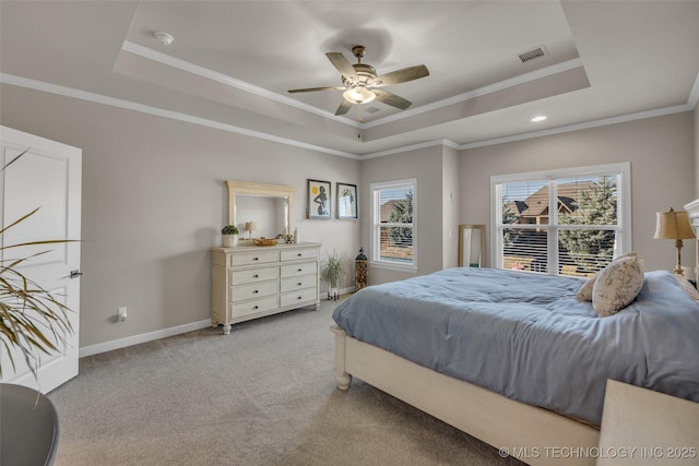 bedroom featuring ornamental molding, ceiling fan, and a tray ceiling