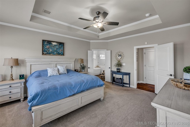 carpeted bedroom featuring ceiling fan, a tray ceiling, and ornamental molding