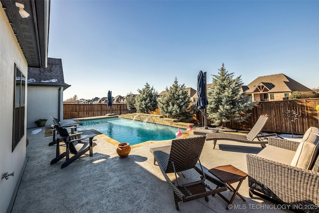 view of pool with pool water feature and a patio area