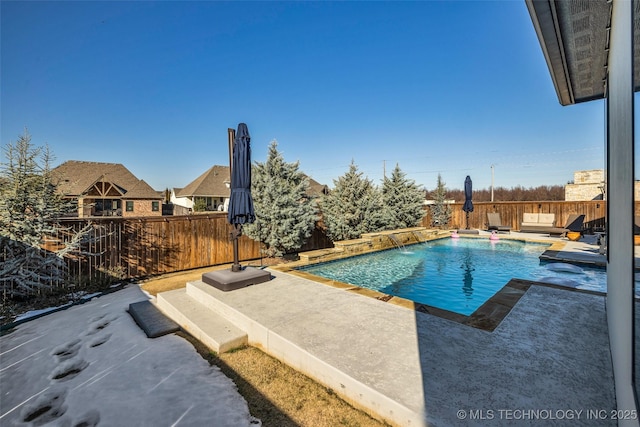 view of swimming pool with a patio and pool water feature