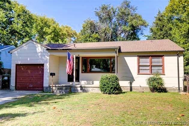 ranch-style house with a garage, a porch, and a front lawn