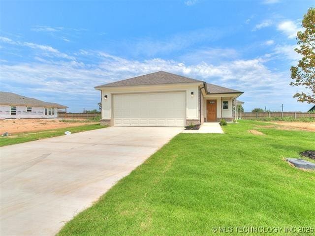 view of front of home with a front yard and a garage