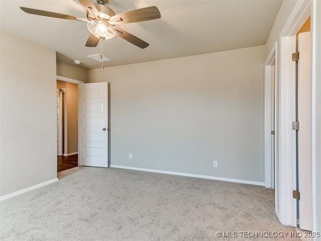 unfurnished bedroom featuring ceiling fan and light carpet