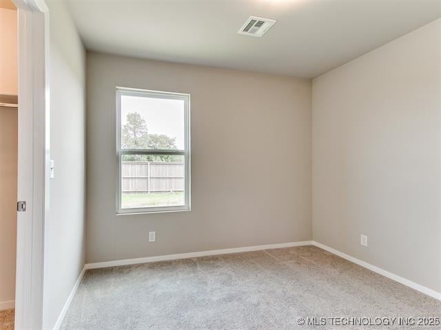 carpeted spare room with plenty of natural light