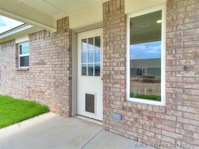 property entrance featuring a patio