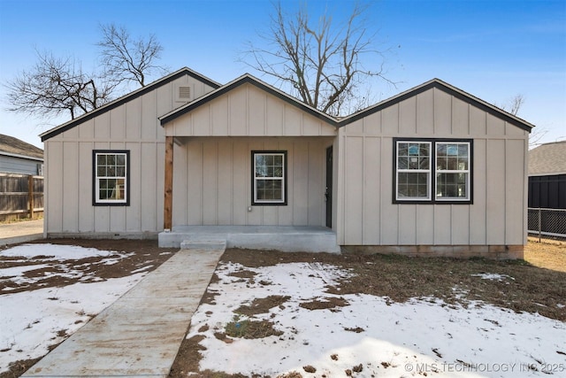 view of front of home featuring fence and board and batten siding