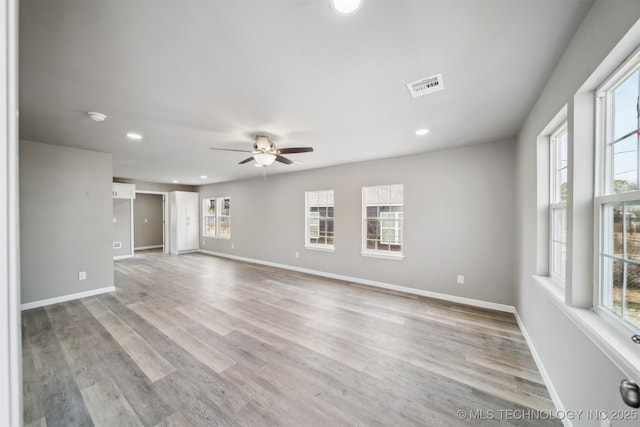 unfurnished living room featuring ceiling fan and light wood-type flooring