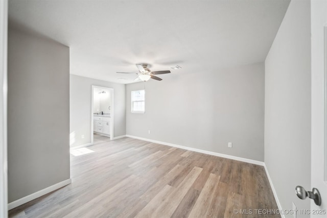 unfurnished room with ceiling fan, sink, and light hardwood / wood-style flooring