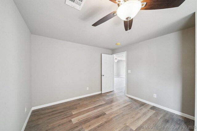 spare room with ceiling fan and hardwood / wood-style floors