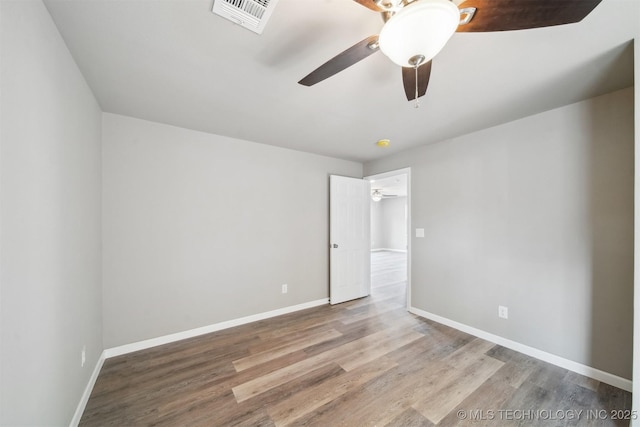 unfurnished bedroom featuring wood finished floors, visible vents, and baseboards