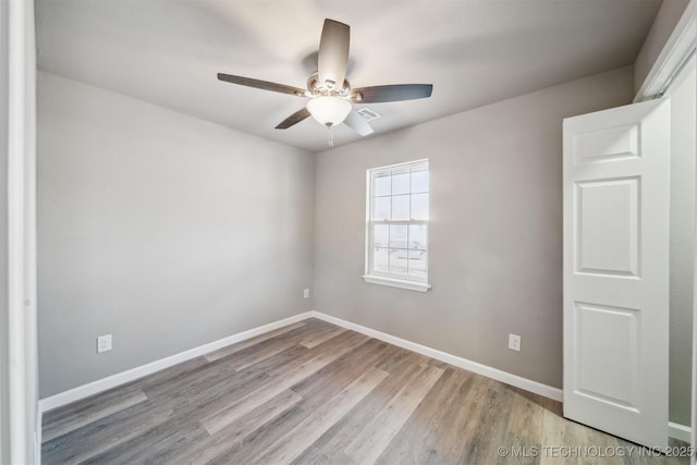 unfurnished room featuring light wood-type flooring and ceiling fan