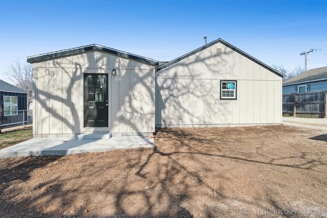 back of property with a patio area and fence