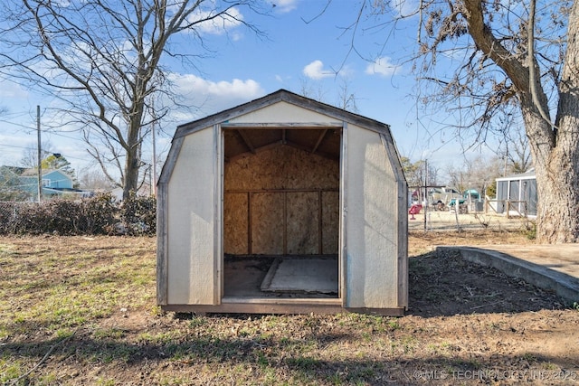 view of shed featuring fence