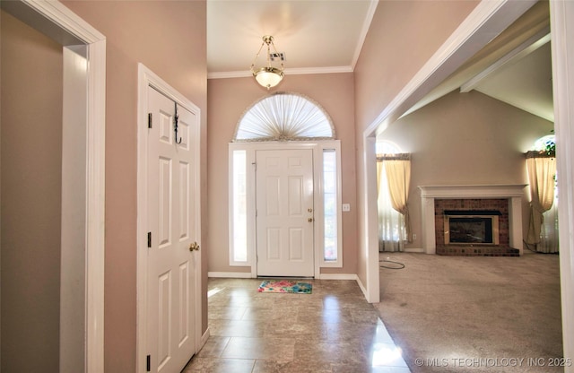 carpeted foyer entrance with a high ceiling, a fireplace, and a wealth of natural light