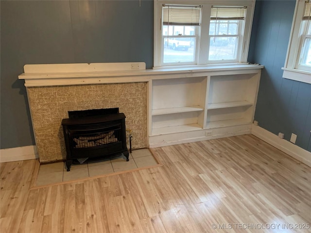 details with wood-type flooring and a wood stove