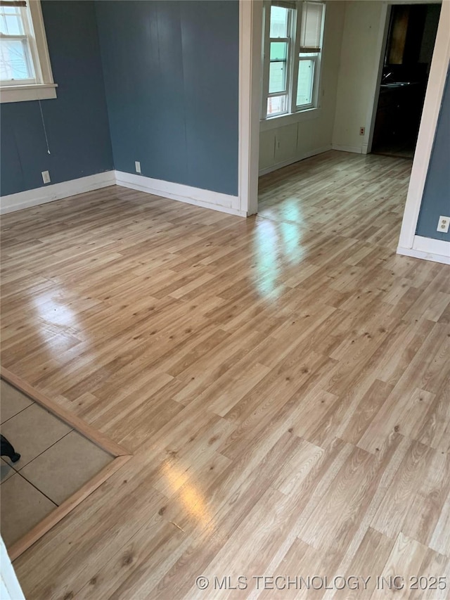 spare room with light wood-type flooring