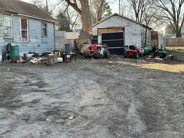 view of yard featuring a garage and an outdoor structure