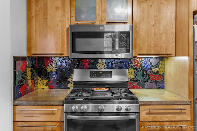 kitchen with decorative backsplash and appliances with stainless steel finishes