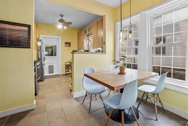 dining room with ceiling fan and light tile patterned flooring