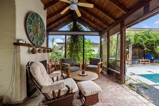 sunroom / solarium featuring ceiling fan, wood ceiling, and lofted ceiling with beams