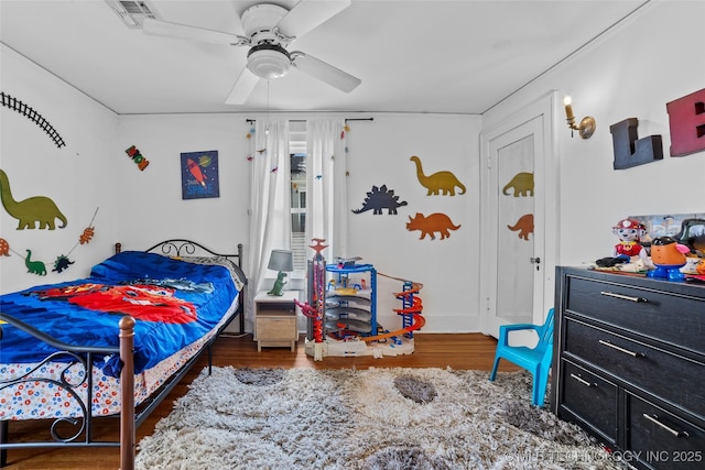 bedroom featuring ceiling fan and dark hardwood / wood-style flooring