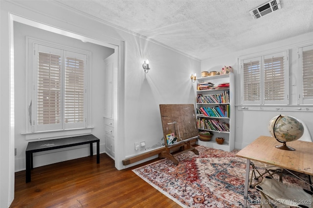 interior space featuring a textured ceiling, dark hardwood / wood-style flooring, and a healthy amount of sunlight