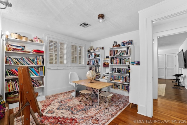 office space with wood-type flooring and a textured ceiling