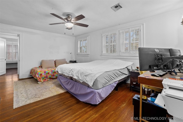 bedroom featuring ceiling fan and dark hardwood / wood-style flooring