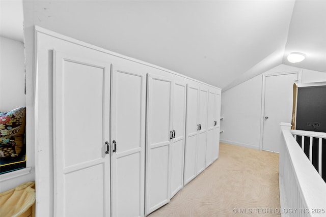 hallway with vaulted ceiling