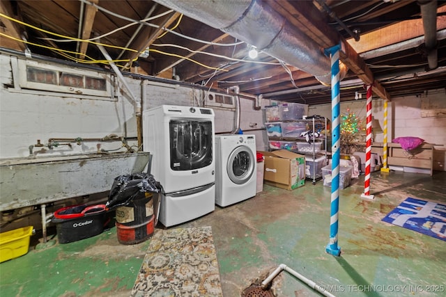 basement with washer and clothes dryer and sink