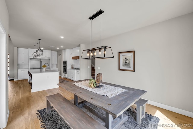 dining room with light wood-type flooring and sink