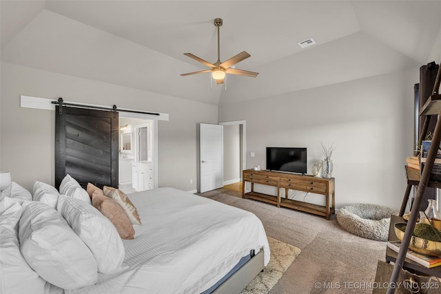 carpeted bedroom with ensuite bathroom, ceiling fan, a tray ceiling, and a barn door