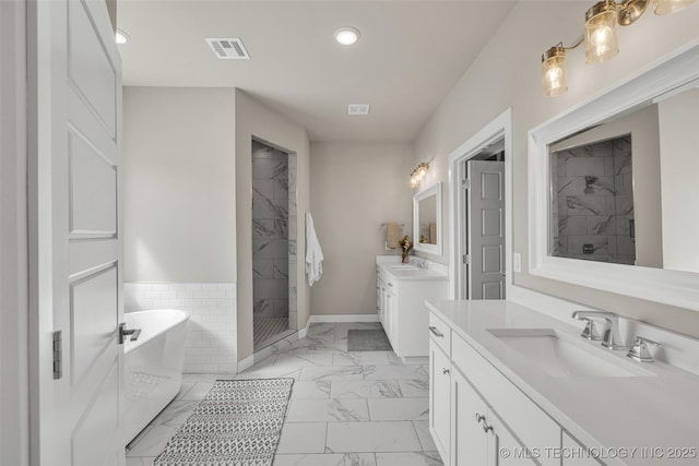 bathroom featuring separate shower and tub and vanity