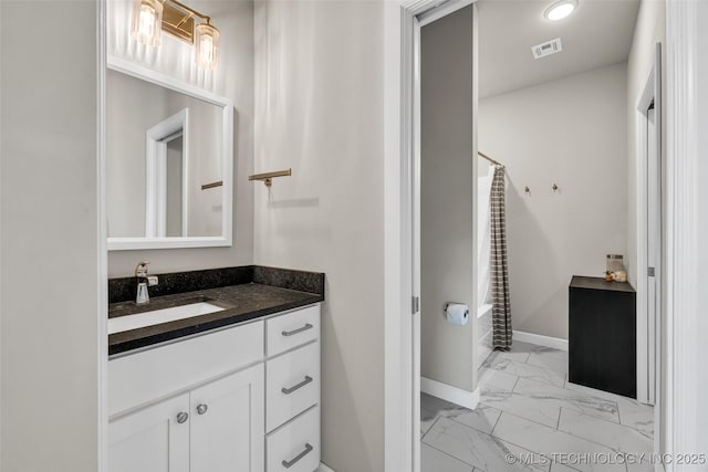 bathroom with curtained shower and vanity