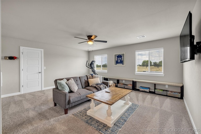 living room featuring carpet floors and ceiling fan