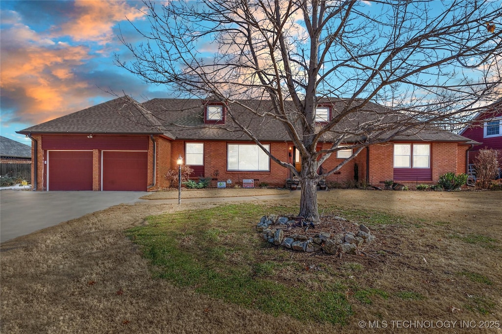 single story home with a lawn and a garage