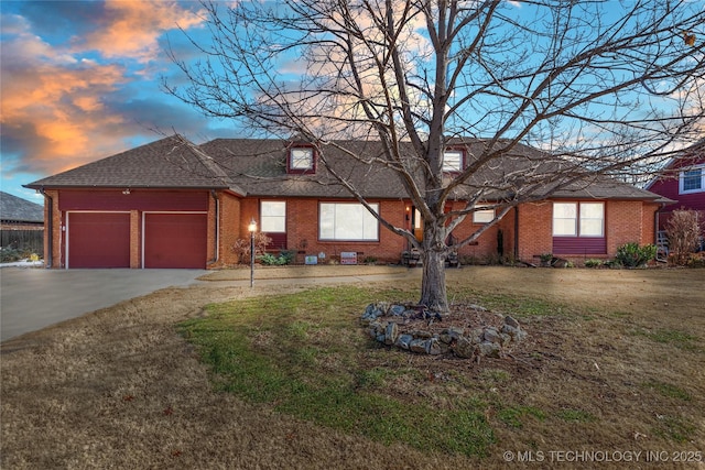 single story home with a lawn and a garage