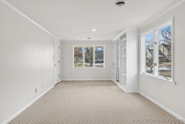 empty room featuring visible vents, crown molding, light carpet, and baseboards