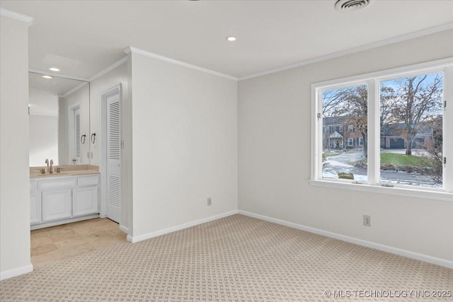 unfurnished bedroom featuring light carpet, baseboards, visible vents, and crown molding