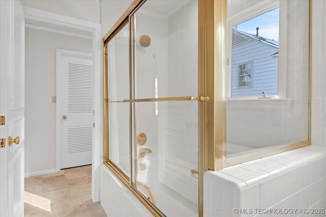 full bath featuring baseboards, combined bath / shower with glass door, and crown molding