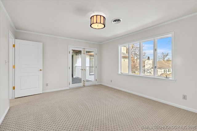 spare room with light carpet, visible vents, ornamental molding, and french doors