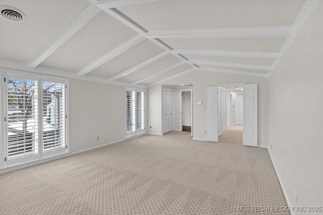 unfurnished bedroom with vaulted ceiling with beams, baseboards, visible vents, and light colored carpet