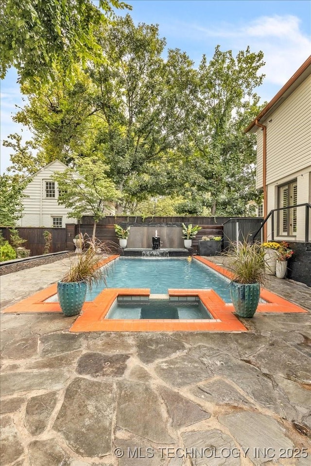 view of pool featuring a fenced backyard, a fenced in pool, and an in ground hot tub