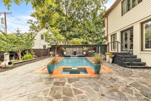 view of swimming pool with a fenced in pool, a fenced backyard, a patio, and an in ground hot tub