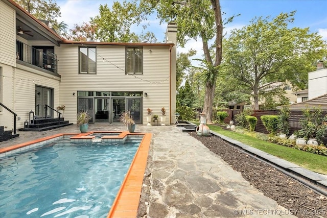 rear view of property featuring a patio, a chimney, entry steps, ceiling fan, and fence