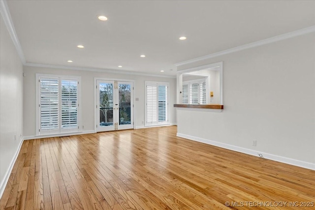 unfurnished living room featuring light wood-style flooring, baseboards, and crown molding