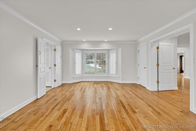 empty room with light wood-type flooring, crown molding, baseboards, and recessed lighting